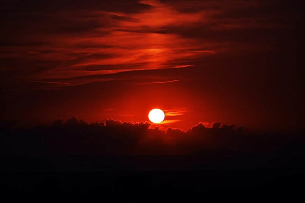 Red moon and fiery sky representing Aries Moon sign energy